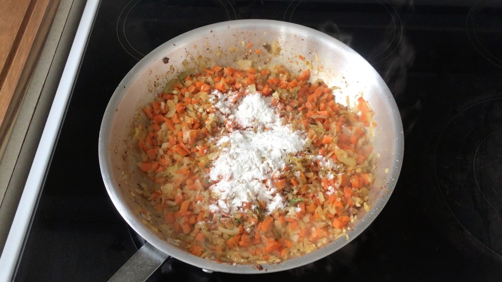 After the onions and carrots have cooked out a little, we added some flour ready for mixing in.